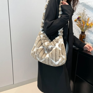 Detailed view of the striped plush tote bag featuring soft pleated faux fur textures