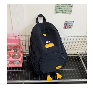 Detail of black nylon cartoon backpack with 3D duck elements and front zip pocket