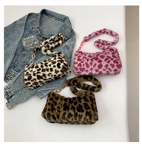 Detailed view of plush leopard print shoulder bags in three colors with chain accents