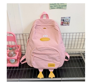 Detailed view of pink cartoon duck backpack with nylon fabric and embroidered patches