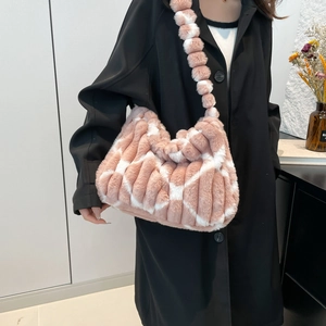 Pink and white checkered plush tote bag with spherical strap on a female model