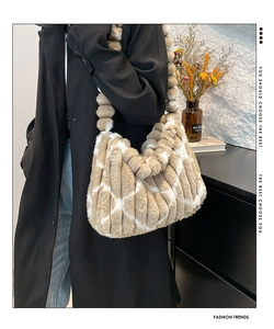 Detail of plush striped tote bag with soft faux fur texture and bubble-shaped strap