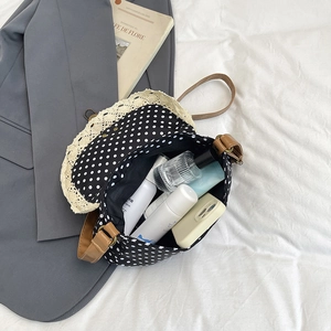 Retro polka dot canvas bag with lace trim and brown strap, showing spacious interior