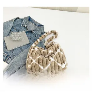 Detailed macro view of light brown and white diamond quilted pattern plush tote bag