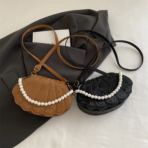 Chic shell-shaped pearl handbags with snakeskin texture in black and brown leather