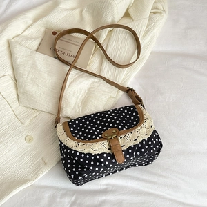Retro canvas crossbody bag with black polka dots, lace trim, and brown leather accents