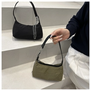 Detail of minimalist nylon tote bags in black and olive green with silver metal chains