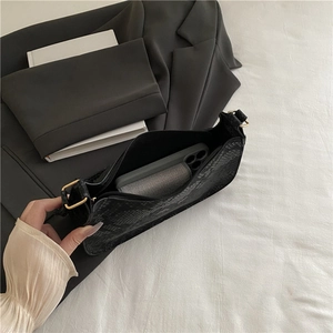 Chic black snakeskin embossed shoulder bag for women with golden hardware details