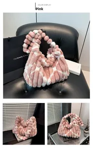Detail of pink and white striped plush tote bag with decorative fur ball handles