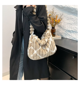 Detail of plush tote bag with striped texture and spherical shoulder strap detail