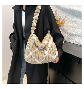 Detail of plush striped tote bag featuring beige and white soft faux fur texture