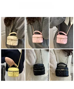 Close-up of quilted mini vanity bags in multiple colors with leather chain straps