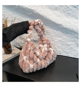 Close-up of the plush faux fur texture and pink-brown striped design on a tote bag