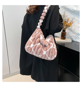 Detail of plush striped tote bag featuring pink and white faux fur texture and thick strap