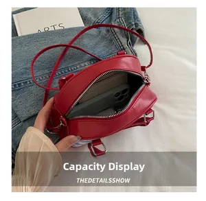 Top view of the red apple handbag showing interior space for phone and wallet