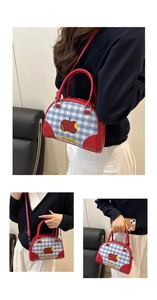 Detail view of small bowling bag with blue plaid patterns and red apple illustration