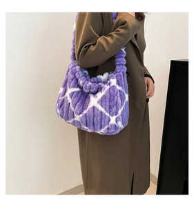 Detail of plush purple and white checkered tote bag with a soft wide shoulder strap