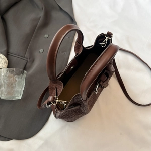 Borsa a mano marrone con trama intrecciata, manici cilindrici e tracolla regolabile