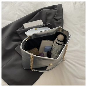 Interior view of silver tote bag showing capacity for umbrella, phone and cosmetics