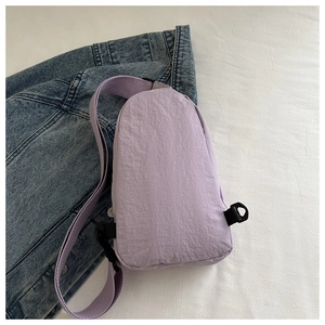 Detail view of light purple waterproof nylon chest bag with adjustable strap and buckle