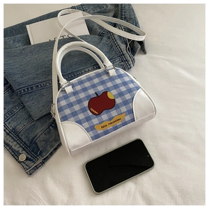 Detailed top view of a mini checkered crossbody bag with an apple logo and leather straps