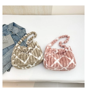 Detail of plush tote bags in khaki and pink featuring white cross-pattern faux fur texture