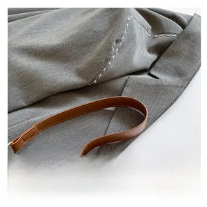 Detail of premium brown leather handle with fine stitching on vintage monogram handbag