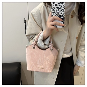 Détail d'un sac seau rose clair avec texture marbrée et logo doré DX Do&thinks gravé