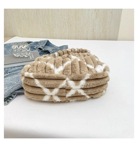 Detail of plush striped tote bag featuring brown and white faux fur in a pleated design