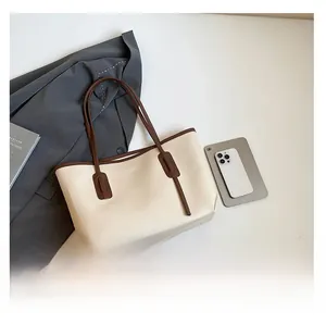 Detailed top view of a cream white large tote bag with brown straps for daily use