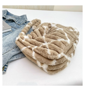 Detail of soft striped plush tote bag with faux fur texture and matching handles
