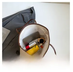 Large capacity tote bag interior showing space for a tablet, umbrella and makeup items