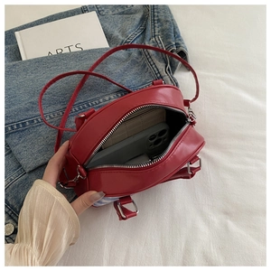 Detail of red plaid handbag interior showing space for smartphone and wallet items