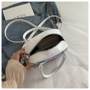 Top view of striped round crossbody bag showing internal space for a short wallet