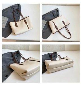Detail view of large cream tote bag with brown handles and contrast trim for work