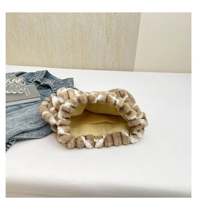 Detail of plush tote bag interior with magnetic closure and yellow fabric lining