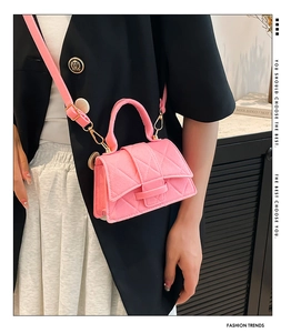Close-up of pink quilted felt mini bag featuring gold metal hardware and flap closure