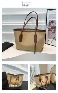 Detail view of khaki tote bag with contrast brown handles and leather texture finish