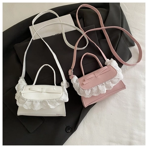 Detail of ballet style crossbody bag with lace heart trim and a sweet bow decoration
