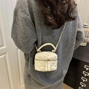 Elegant white quilted mini box bag with chain strap shown on model for size reference
