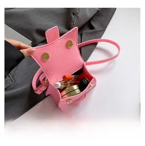 Detailed internal view showing capacity for cosmetics in pink mini crossbody bag