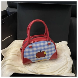 Red leather and plaid Boston bag with apple embroidery in a luxury gift box packaging