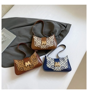 Detailed flat lay of three vintage baguette bags in beige, dark brown, and navy colorways