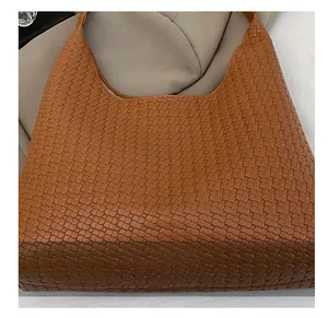 Detailed view of caramel brown woven leather hobo bag with intricate texture and craftsmanship
