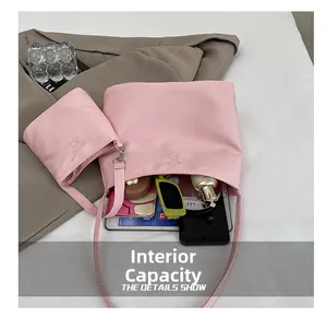 Detail view of pink tote bag showing large capacity for tablet, phone, and cosmetics