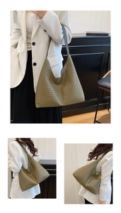Detail of green woven leather texture on hobo shoulder bag with large capacity