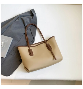 Close-up of a large capacity beige and brown leather tote bag for office and commute