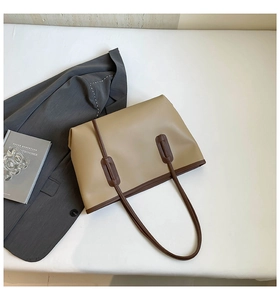 Detail shot of the contrast color leather tote bag showing smooth PU material and slim straps