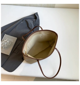 Interior view of large capacity cream tote bag with brown handles and zipper detail