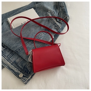 Dettaglio della mini borsa rossa con bordo in pizzo bianco e finiture in metallo
